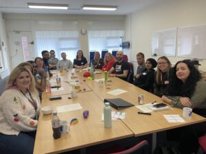 A group photo of people around a table.